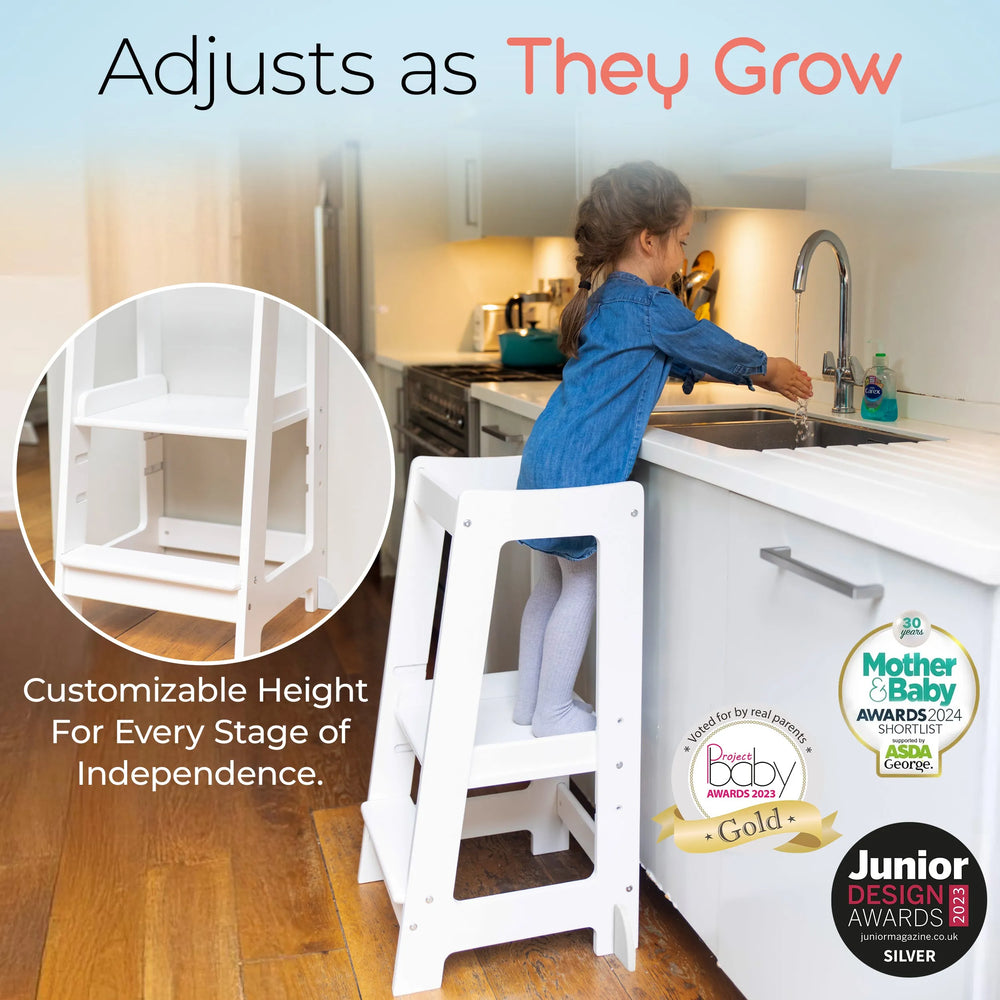 white adjustable toddler tower positioned at kitchen sink for easy reach with awards